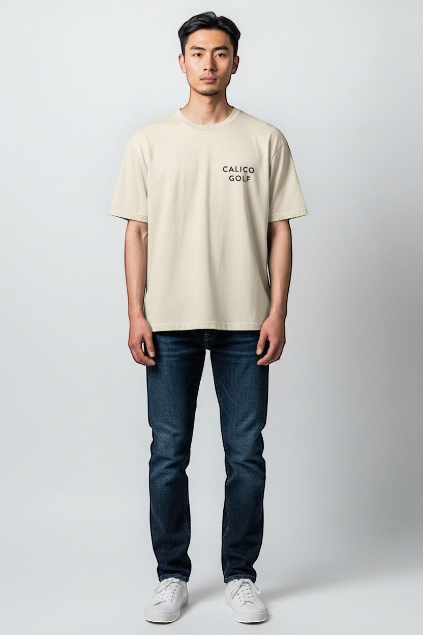 Calico Golf cream 100% USA cotton t-shirt. Garment dyed for a lived in feel. Relaxed unisex fit.