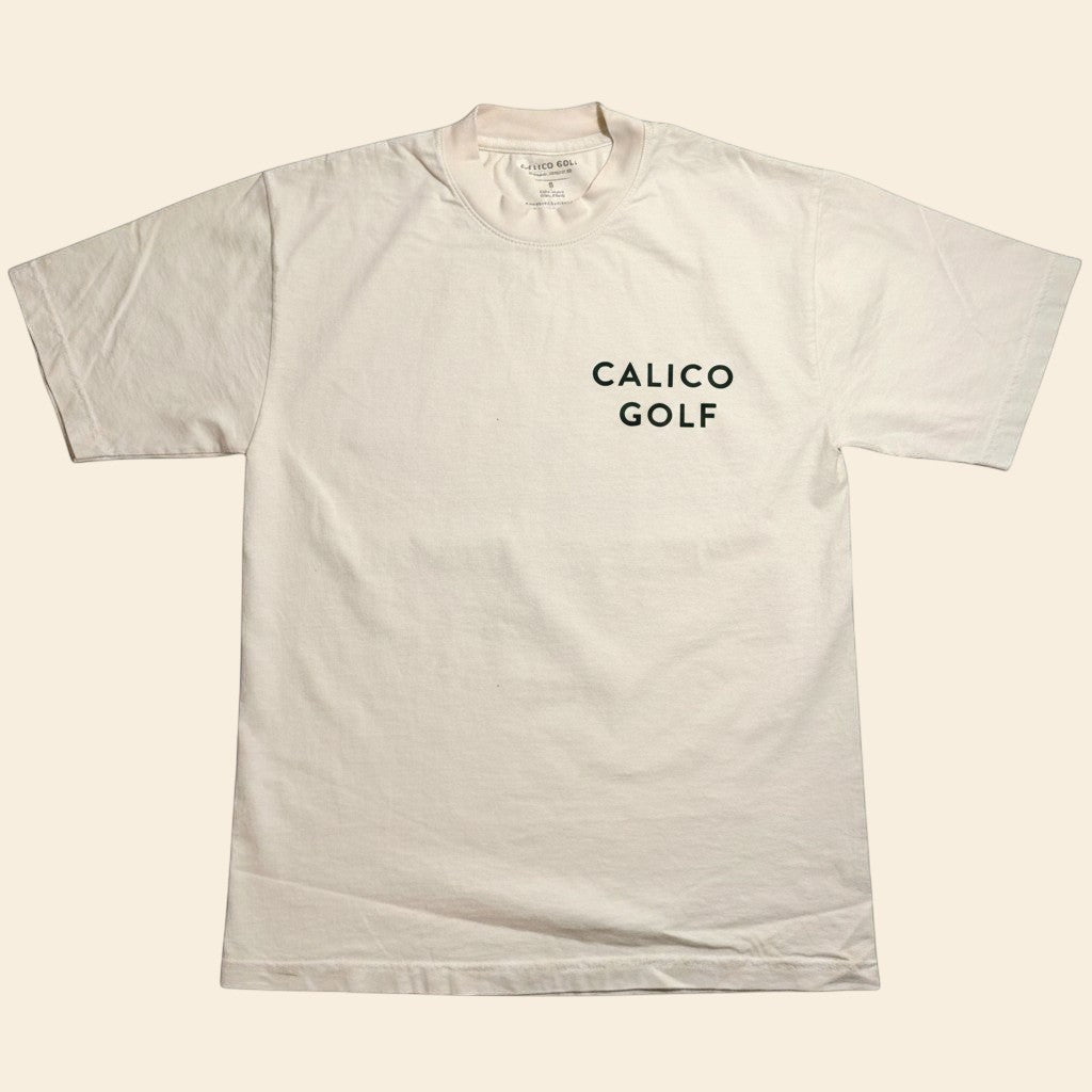 Calico Golf cream 100% USA cotton t-shirt. Garment dyed for a lived in feel. Relaxed unisex fit.